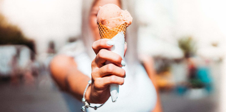 Woman Holding an Ice Cream in Front of Her Face